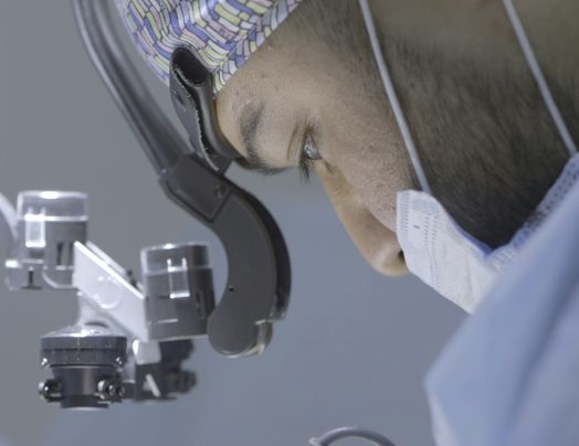 Close-up of surgeon performing operation. Action. Focused and serious surgery by surgeon